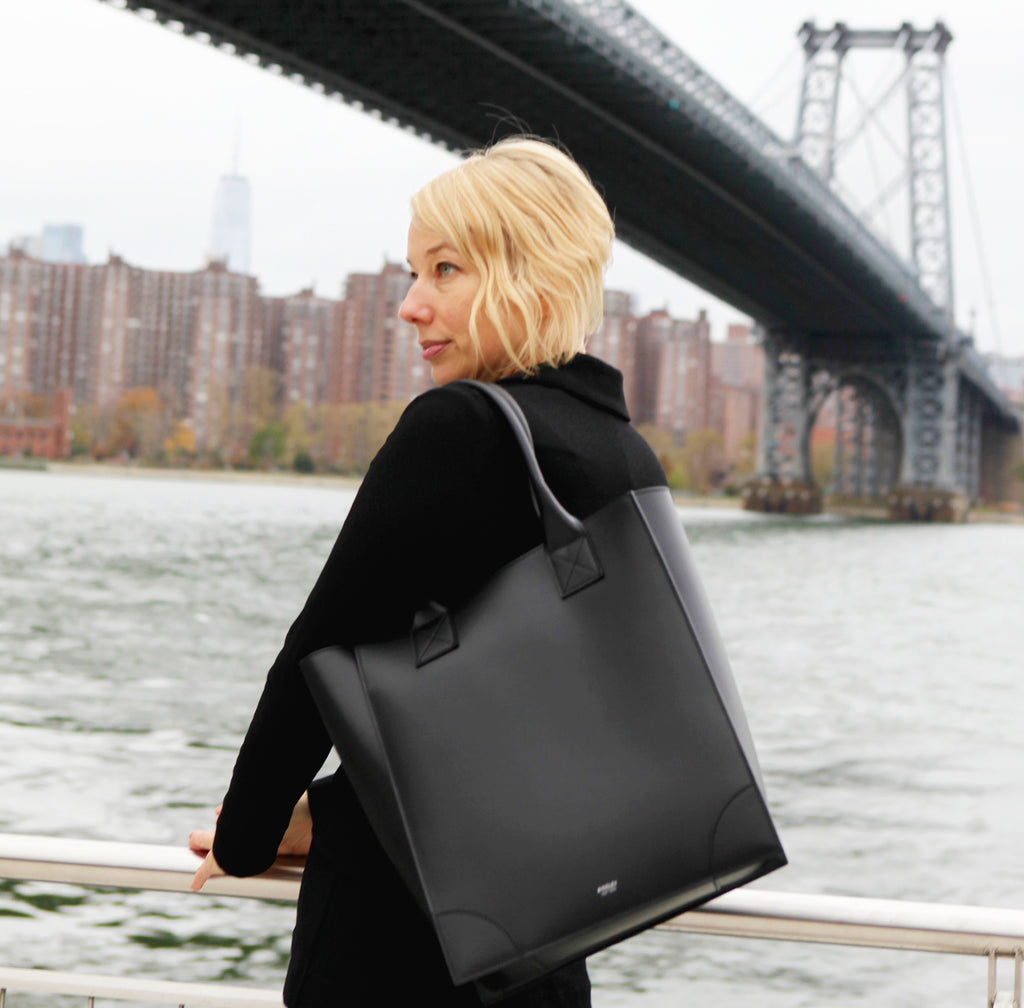 Black vertical leather tote bag with long handles to wear over the shoulder. Structured body with smooth Italian Leather.